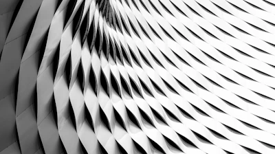 A curved facade covered in white latticework